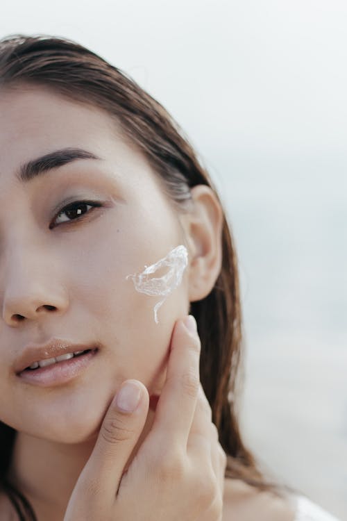 Woman applying face cream